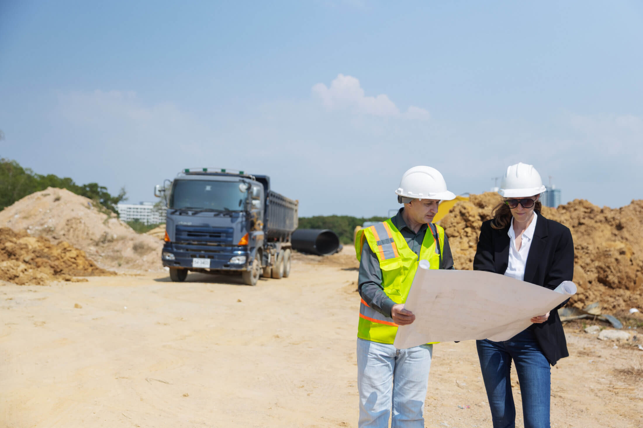 two-construction-professionals-examine-site-bluepr-2026-03-20-03-53-16-utc